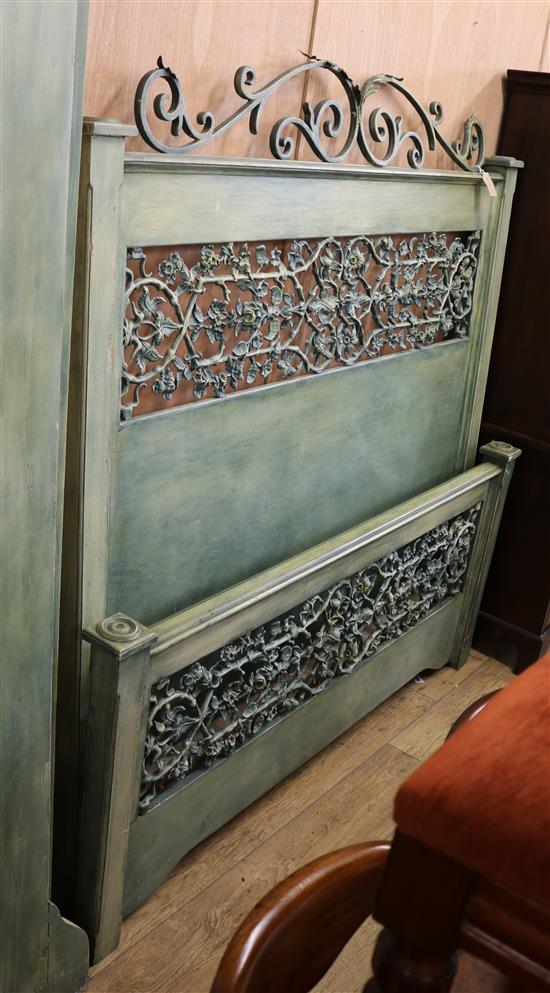 A light green wood and cast metal double bedstead W.165cm